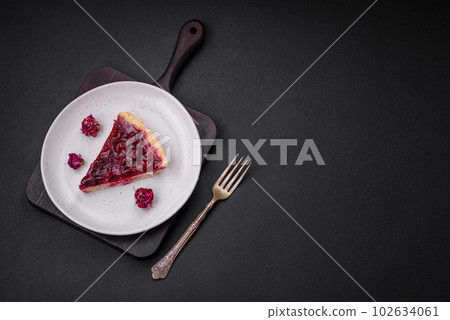Delicious fragrant sweet pie with cherry berries on a ceramic plate 102634061
