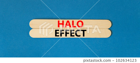 Halo effect and psychological symbol. Concept words Halo effect on beautiful wooden stick. Beautiful blue table blue background. Business psychological and Halo effect concept. Copy space. 102634123