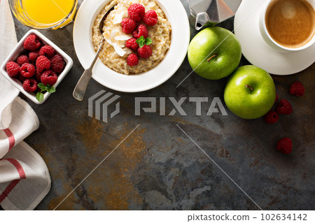 Steel cut oatmeal porridge with raspberry and coconut Steel cut oatmeal porridge with raspberry and coconut 102634142