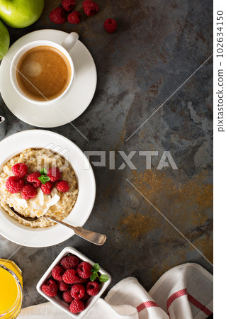 Steel cut oatmeal porridge with raspberry and coconut 102634150