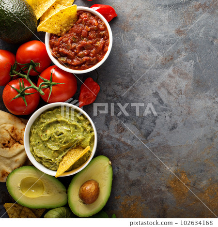 Homemade hummus, salsa and guacamole with corn chips Homemade hummus, salsa and guacamole with corn chips 102634168