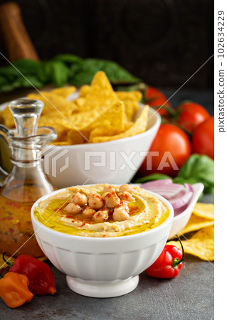 Homemade hummus in a white bowl 102634229