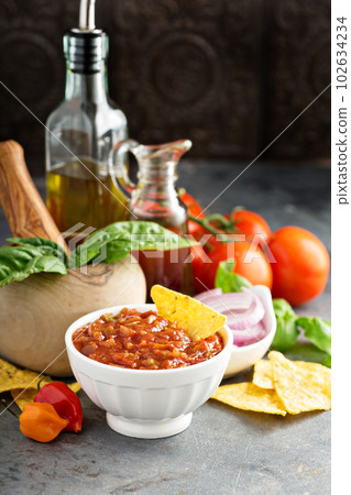 Homemade spicy tomato salsa with vegetables and olive oil 102634234