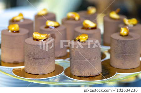 Brown chocolate delicious desserts for the candy bar. The concept of desserts for the holiday. Brown chocolate delicious desserts for the candy bar. The concept of desserts for the holiday. 102634236