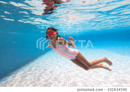 Child in swimming pool on ring toy. Kids swim. Child in swimming pool on ring toy. Kids swim. 102634590