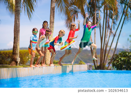 Kids jump into swimming pool. Summer water fun. Kids jump into swimming pool. Summer water fun. 102634613