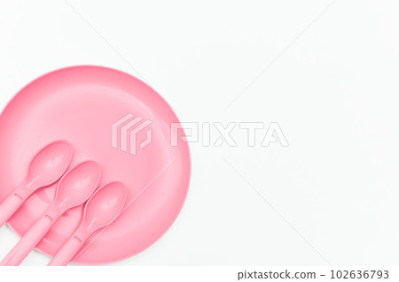 Pink plastic spoons and plate for camping, isolated on white Pink plastic spoons and plate for camping, isolated on white 102636793