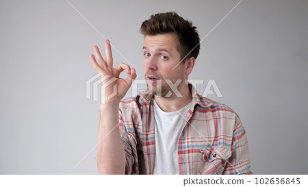 The European young man shows the okay gesture, saying everything is done excellently 102636845