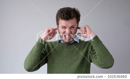 The European young man covers his ears. He doesn't want to hear the uncomfortable truth The European young man covers his ears. He doesn't want to hear the uncomfortable truth 102636860