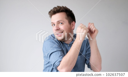European young man playfully dances and moves with joy European young man playfully dances and moves with joy 102637507
