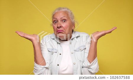 Senior European woman shrugs her shoulders in confusion 102637588