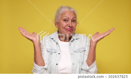 Senior European woman shrugs her shoulders in confusion Senior European woman shrugs her shoulders in confusion 102637825