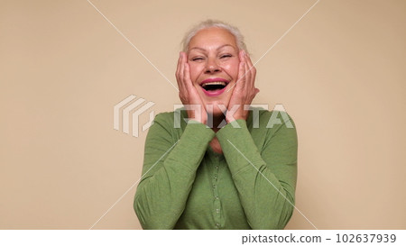 An elderly European woman is laughing loud 102637939