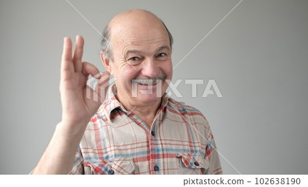 Senior man smiling positive doing ok sign with hand and fingers. Senior man smiling positive doing ok sign with hand and fingers. 102638190