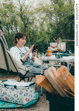 Touching a smartphone at a women's solo camp 102638974