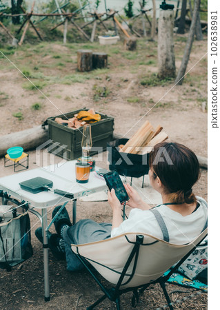 Touching a smartphone at a women's solo camp 102638981