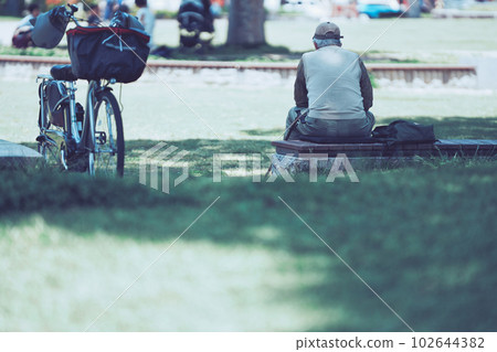 Rear view of a man sitting in the park Rear view of a man sitting in the park 102644382