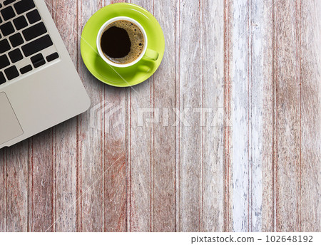 Office table with laptop computer and coffee cup on wood table Office table with laptop computer and coffee cup on wood table 102648192