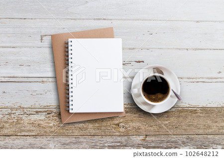 Blank notepad and coffee cup on white wooden 102648212