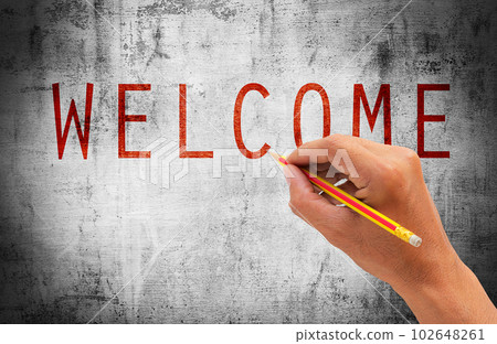 Hand writing text with WELCOME on grunge background 102648261