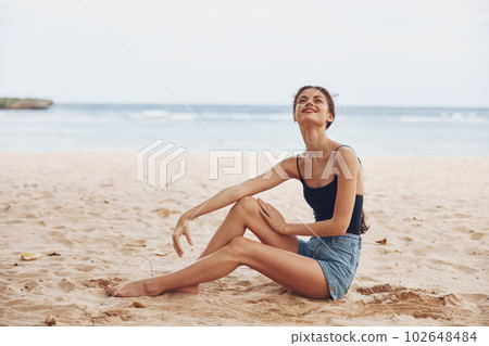 woman sand long vacation sea travel sitting freedom smile hair beach nature 102648484