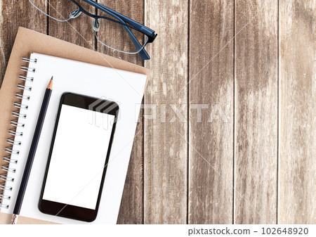 Top view notebook on wooden table 102648920