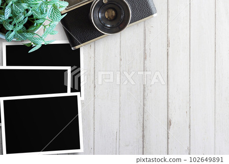 two blank photo frames and glasses with cup of coffee on old wooden table 102649891