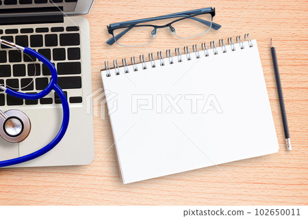 Laptop computer, stethoscope and notebook on office desk Laptop computer, stethoscope and notebook on office desk 102650011