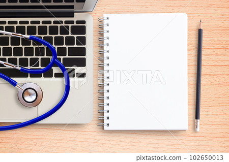 Laptop computer, stethoscope and notebook on office desk Laptop computer, stethoscope and notebook on office desk 102650013