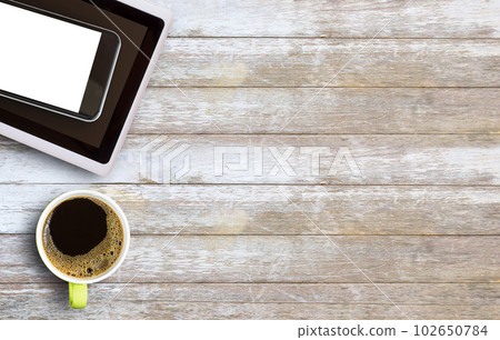 Hot coffee in a green cup on old wooden table Hot coffee in a green cup on old wooden table 102650784