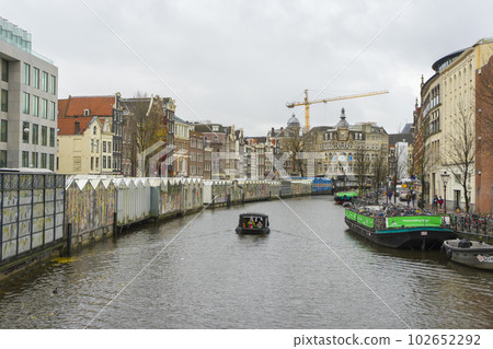 Amsterdam, Netherlands - Nov 27, 2019 : The canal called Singel with floating flower market stalls in Amsterdam, Netherlands on Nov 27, 2019. 102652292