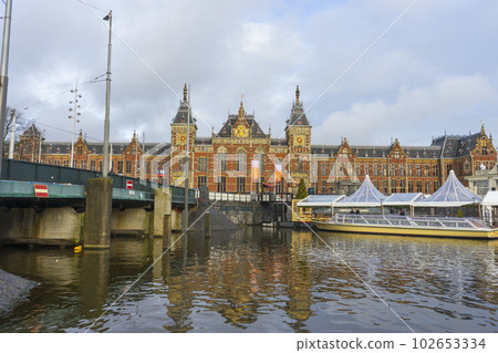 Amsterdam, Netherlands - Nov 27, 2019 : Beautiful Amsterdam Central station at twilight in Amsterdam, Netherlands on Nov 27, 2019. Amsterdam, Netherlands - Nov 27, 2019 : Beautiful Amsterdam Central station at twilight in Amsterdam, Netherlands on Nov 27, 2019. 102653334
