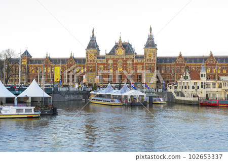 Amsterdam, Netherlands - Nov 27, 2019 : Beautiful Amsterdam Central station at twilight in Amsterdam, Netherlands on Nov 27, 2019. Amsterdam, Netherlands - Nov 27, 2019 : Beautiful Amsterdam Central station at twilight in Amsterdam, Netherlands on Nov 27, 2019. 102653337