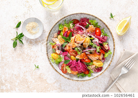 Salad of grilled salmon fillet, tomato and fresh lettuce salad, healthy food, lunch, top view Salad of grilled salmon fillet, tomato and fresh lettuce salad, healthy food, lunch, top view 102656461