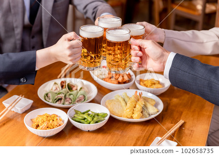Men and women of colleagues, colleagues, bosses and subordinates who have a toast, year-end party, New Year's party, drinking party, banquet with beer mugs at an izakaya 102658735