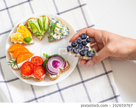 Rainbow sandwiches heart shape on white table Rainbow sandwiches heart shape on white table 102659767