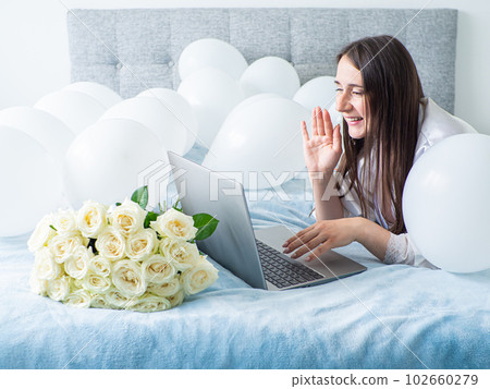 Woman lying on bed with decorations with balloons for Birthday party Woman lying on bed with decorations with balloons for Birthday party 102660279