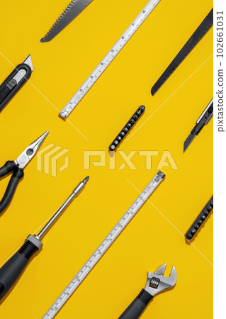 Flat lay composition with set of home repair tools on bright yellow background. Top view pattern with copy space. Flat lay composition with set of home repair tools on bright yellow background. Top view pattern with copy space. 102661031