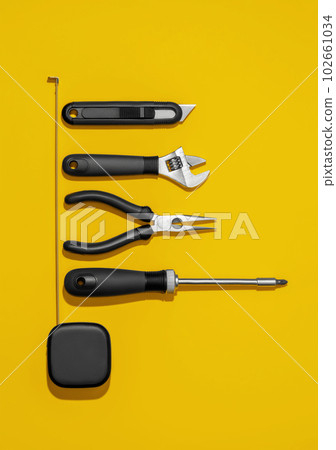 Flat lay composition with set of home repair tools on bright yellow background. Top view pattern with copy space. Flat lay composition with set of home repair tools on bright yellow background. Top view pattern with copy space. 102661034