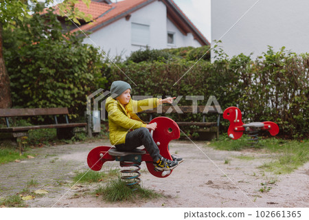 Funny cute happy baby playing on the playground. The emotion of happiness, fun, joy. Smile of a child. boy playing on the playground Funny cute happy baby playing on the playground. The emotion of happiness, fun, joy. Smile of a child. boy playing on the playground 102661365