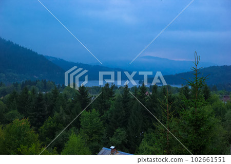 landscape of Lake Bicaz surrounded by mountains in the evening 102661551