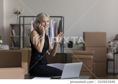 Positive middle aged internet shop owner working in storage space Positive middle aged internet shop owner working in storage space 102663846