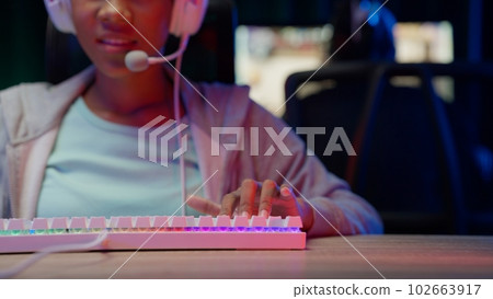 Game streamer using pc setup playing multiplayer first person shooter Game streamer using pc setup playing multiplayer first person shooter 102663917
