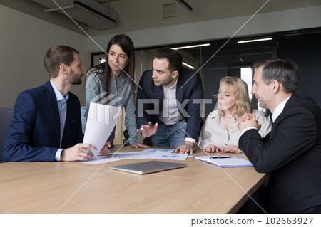 Diverse business team colleagues working on project plan 102663927