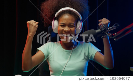Game streamer using pc setup playing multiplayer first person shooter 102664077