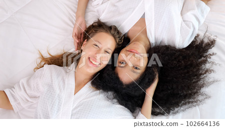 Cheerful close friends women expressing happy face with smile to camera Cheerful close friends women expressing happy face with smile to camera 102664136