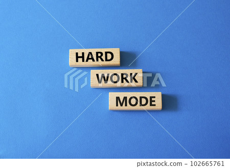 Hard Work Mode symbol. Concept word Hard Work Mode on wooden blocks. Beautiful blue background. Business and Hard Work Mode concept. Copy space Hard Work Mode symbol. Concept word Hard Work Mode on wooden blocks. Beautiful blue background. Business and Hard Work Mode concept. Copy space 102665761