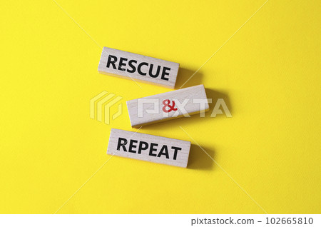 Rescue and Repeat symbol. Wooden blocks with words Rescue and Repeat. Beautiful yellow background. Business and Rescue and Repeat concept. Copy space. 102665810