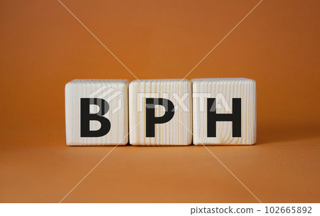 BPH - Benign Prostatic Hyperplasia symbol. Wooden cubes with word BPH. Beautiful orange background. Medical and BPH concept. Copy space. 102665892