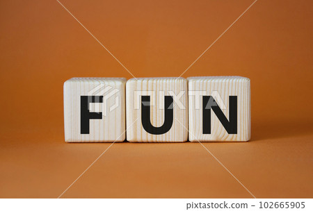 FUN symbol. Wooden cubes with word FUN. Beautiful orange background. FUN concept. Copy space. FUN symbol. Wooden cubes with word FUN. Beautiful orange background. FUN concept. Copy space. 102665905